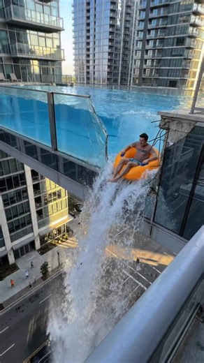 Glass Pool Between Skyscrapers Collapses… Guy on a Float Gets Stuck Hanging 😳💦 A glass pool suspended between skyscrapers suddenly breaks. Water pours out, everyone screams—then a guy on a round float somehow doesn’t fall because the float gets caught on the broken edge, leaving him dangling in midair. Pure luck. People below are filming in total shock. #glasspool #skyscraper #wtf #fail #funny | The.worldai