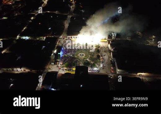 Fireworks explode over a cheering crowd gathered in a city square at night Stock Video Footage - Alamy