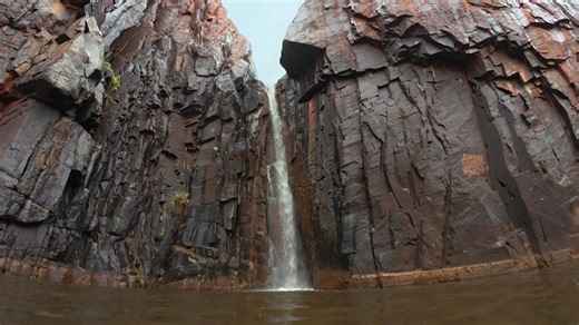 A waterfall gushes at Python Pool in WA's Pilbara region.