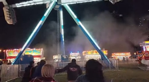 Carnival Ride Malfunctions Mid-Spin, Sparks Fly as Crowd Watches in Shock County Fairgrounds â€” A terrifying mechanical failure unfolded at a nighttime carnival after a high-speed amusement ride malfunctioned mid-operation, sending sparks flying as the structure partially collapsed while riders were still suspended. Video from the scene shows the ride swinging at full momentum when a sudden failure causes one side to drop unevenly, scraping metal against the support frame. Bright sparks erupt b