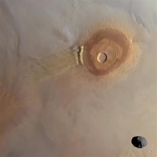 Phobos Moon above Martian Dust Storm near Volcano | Europe's Mars Express FriendsofNASA.org | Full Article: https://www.friendsofnasa.org/2025/12/phobos-moon-above-martian-dust-storm.html The European Space Agency (ESA) Mars Express spacecraft's High Res­o­lu­tion Stereo Cam­era (HRSC) captured these views of the Martian moon Phobos above a Martian dust storm near Pavonis Mons. Pavonis Mons (Latin for "peacock mountain") is a large shield volcano located in the Tharsis region of the planet Mars.