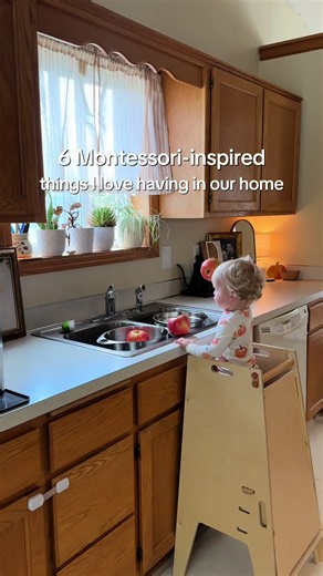 These are 6 Montessori-inspired things I love having in our home 🤍 1. Toddler Tower: Makes it easier for Joseph to be part of what we’re doing in the kitchen instead of just watching from the sidelines. 🧑🏼‍🍳 2. Pikler Set: Gives him a place to climb, move, and challenge his body through play.🙌 3. Forward-Facing Bookshelf: Keeps his books visible and easy for him to choose from on his own.📚 4. Child-Sized Table: Gives him a space that’s actually sized for him to play, create, snack, and wor