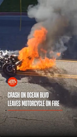 Long Beach Classic on Instagram: "A video sent to us shows the aftermath of a motorcycle accident on Ocean Boulevard, where a motorcycle can be seen on fire following a crash. The footage captures the scene shortly after the collision, showing bystanders attempting to help as emergency responders arrive. The motorcycle appears heavily damaged, with flames visible, while an injured rider is seen receiving assistance. The video does not show the moment of impact. Based on information shared with u