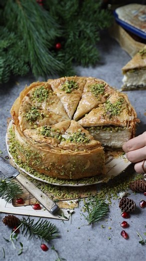 Happy New Year, everyone! Here is one of the most-made and most-loved recipes from my page. This Baklava Cheesecake combines two decadent treats into one special dessert: a creamy cheesecake encased in sweet, syrup-soaked layers of phyllo and pistachios! I used the phyllo recipe from my cookbook, but the recipe for this cheesecake can be found on my website. Recipe 🔗 https://turkuazkitchen.com/recipe/baklava-cheesecake/ | Turkuaz Kitchen