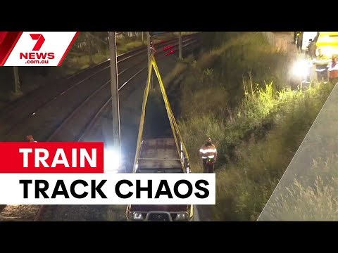 Car crashes onto train tracks | 7NEWS