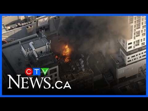 Chopper video captures a big explosion from a rooftop fire in downtown Toronto