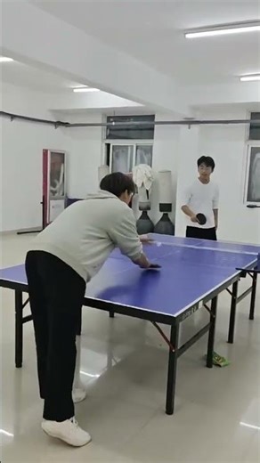 Friends share laughter during playful ping pong trick in Jiangxi, China