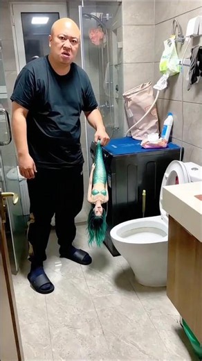He throws the mermaid out the window