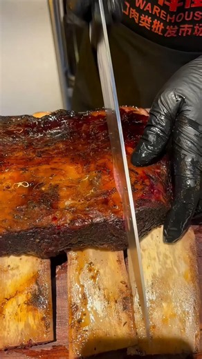 Behold the glorious smoke ring! Slicing into a perfectly smoked rack of tender beef short ribs