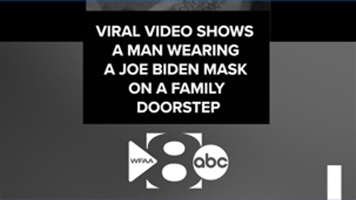 Viral video shows man wearing a Joe Biden eating a banana on a family's doorstep