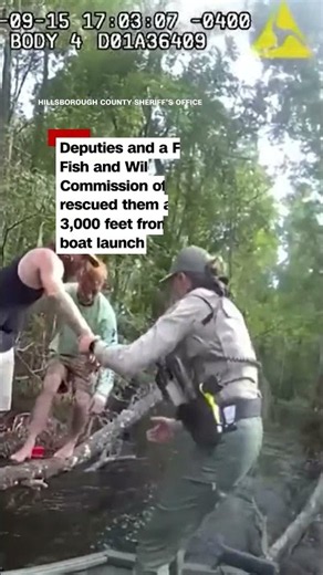 Boaters cling to tree after boat capsizes