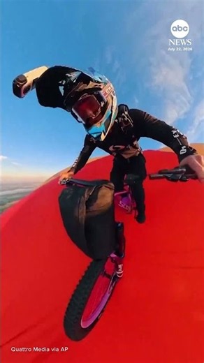 Daredevil rides bike off flying hot air balloon