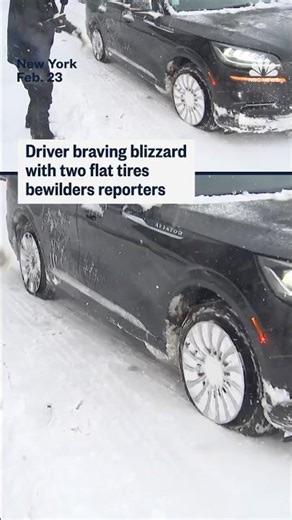 Driver braving blizzard with two flat tires bewilders reporters