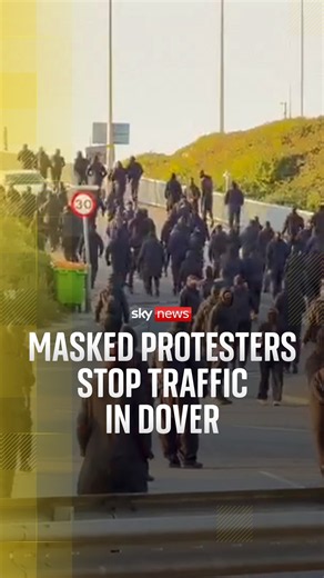 Masked protesters stop traffic in Dover