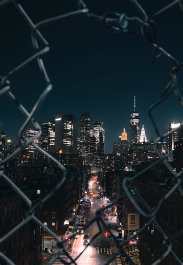 Steal these Adobe Lightroom settings to turn a night city photo into something cinematic.👇 This photo was taken on the Brooklyn Bridge, looking back toward the city. Instead of shooting clean, I framed it through the chain-link fence - a frame-within-a-frame to add grit, depth, and a bit of tension. The fence creates separation, the street pulls you in, and the skyline becomes the payoff. Here’s exactly how I edited this image in Adobe Lightroom, step by step: 1️⃣ Tone Curve – Built a subtle S-