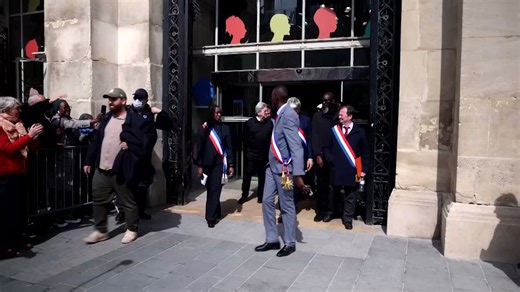 Mayor of Paris suburb receives eye drops for tear gas after joining protest