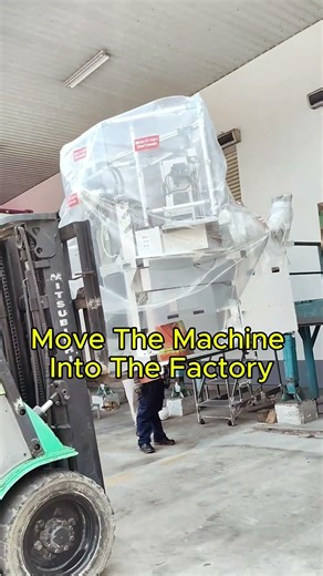 A close-up view of moving the machine into the factory.