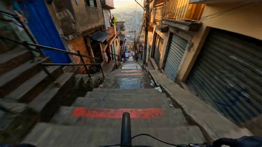 Seedance 2.0 on @haimeta_ai is next level. It doesn’t even look AI-generated anymore, it looks filmed.Prompt:FORMAT: 15s / 180 BPM / ONE CONTINUOUS SHOT / 360 POV downhill stair run, viral energy, max chaos SUBJECTS: First-person cyclist, handlebars and front wheel flashing low in frame during drops and hard turns. Vendors, laundry, scooters, dogs, chickens, cars, and pedestrians erupt around the rider as sudden obstacles. ENVIRONMENT: Dense Brazilian hillside streets, painted concrete stairs, t