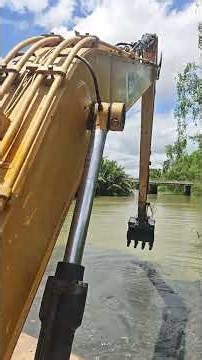 Dredging a canal with an excavator on a barge
