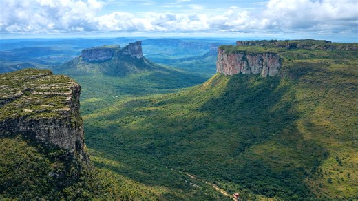 Massive cliffs rising above wide open valleys in Brazil