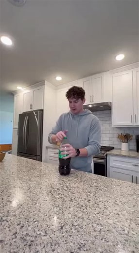 CheKsou Wild on Instagram: "A person unscrews a bottle of soda that was accidentally shaken, causing a massive carbonated eruption that sprays all over the kitchen. The fizzy explosion covers the ceiling, walls, and counter in a dramatic but harmless mess."