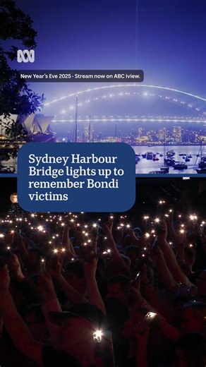 With the Sydney Harbour Bridge illuminated white, and the lights of thousands of torches glowing, the New Year’s Eve crowds stopped to remember and honour the 15 people killed in the Bondi terror attack earlier this month. #ABCNews | ABC News