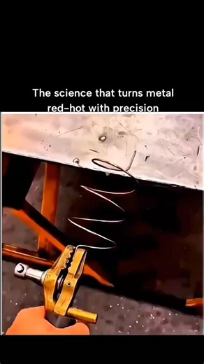GLOBAL Explained on Instagram: "That video is a fascinating demonstration of induction heating, a process used to heat conductive materials (usually metals) without any physical contact. It begins with a copper coil shaped like a spring connected to a specialized power supply via a heavy-duty brass clamp. As the high-frequency alternating current begins to flow through the coil, an intense electromagnetic field is created in the space around it.As the metal wire within the coil reacts to this fi