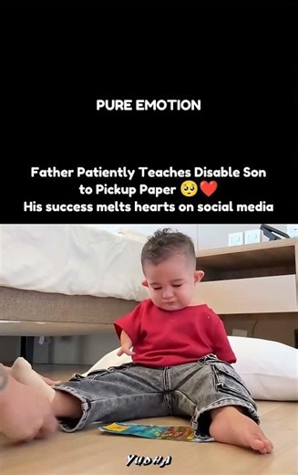 Father Patiently Teaches Disable Son to Pickup Paper