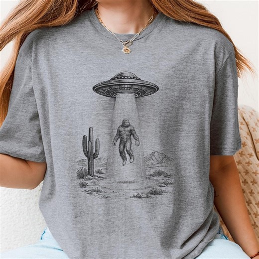 UFO Abducting Bigfoot T-shirt, Funny Alien Sasquatch Shirt, Bigfoot UFO Graphic Tee, Sci Fi Humor Shirt, Cryptid Lover Gift - Etsy