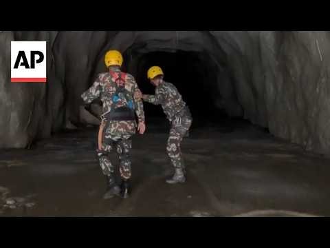 Rescuers search for workers trapped in flooded tunnels at power plants in Nepal