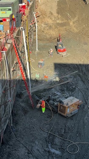Commercial Project Underway The site is currently excavated to approximately 25 feet below grade, with excavation progressing in controlled lifts. An engineered soldier pile and lagging shoring system is installed to resist lateral earth pressures and maintain excavation stability. As excavation advances, tensioned tieback anchors are drilled and installed per the approved shoring plans. Each tieback extends approximately 37 feet into competent soil, where the bonded zone is developed and tensio