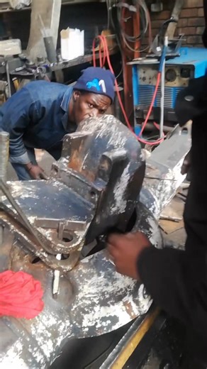 MARKING OFF EXCESSIVE EDGE TO GRIND OFF ON EXCAVATOR' DIFFERENTIAL HOUSING HUB WITH PORTABLE GRINDER