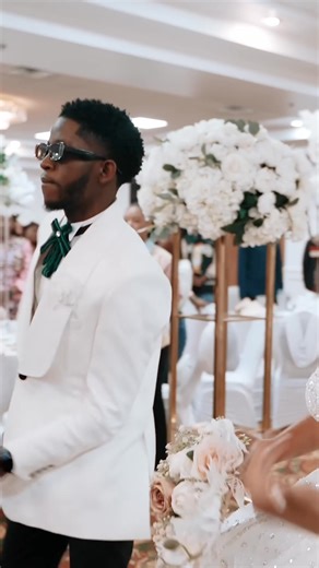 The bride and groom share a dance as their wedding party surrounds them. Moments later, the wedding party enters the hall, celebrating with even more dancing and fun! #Wedding #Bride #Groom #Celebration #Dancing | Benprorecords