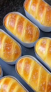 Creamy Coconut Bread 🥰 dough preparation in the mixer bowl bread flour 500g sugar 60g salt 6g one large egg instant yeast 9g milk 270ml knead the dough for 5min butter 35g knead the dough for 7min rest the dough for 60min Custard preparation take a bowl egg yolks 4 sugar 50g corn starch 26g mix well coconut milk 150ml milk 150ml mix well boil on low heat until thickened let it cool separate the dough into 8 pieces make balls cover the dough rest the dough for 15min mak the bread roll the dough 