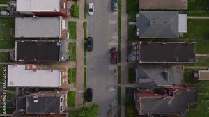 Bird's eye view of a residential neighborhood of an American city from above, capturing houses, streets, and intersections. Urban grid from a unique perspective