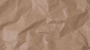 Download Crumpled brown paper stop motion animation, Textured paper background. The concept of sketch pad, design, retro style, wrinkle, frayed, blank for free