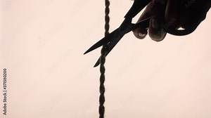 A piece of rope cut with scissors. As a symbol of something not good.