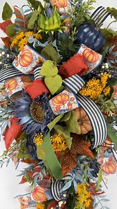 We show y'all PINK fall accents, but what about blue?! These blue pumpkins and sunflowers are the perfect contrast to the green and orange in this fall swag. What do y'all think?! Who else is switching up their fall colors this year? #FallSwags #FallSilkFlorals #MasterSilkFlorals #FloralDesignTips | Southern Charm Wreaths