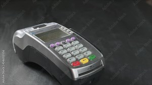 The user makes payment by credit card. Swipe to the terminal of non-cash payment. Man hand with credit card swipe through pos terminal. Banking services of electronic money, making transaction