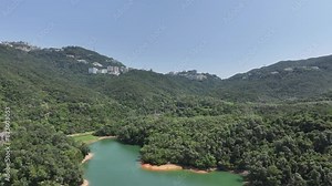 Aerial drone sky view of the main dam of Pok Fu Lam Reservoir in Aberdeen, Hong Kong, adjacent to country parks and residential commercial areas in Wong Chuk Hang