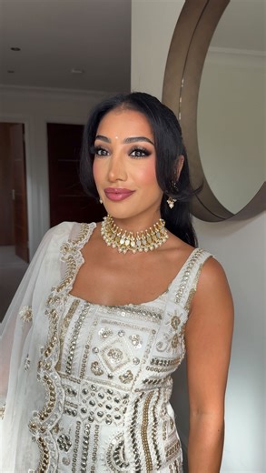 ANCHAL | Content Creator - Podcast Host - Author on Instagram: "nothing beats an Indian glam >>> while it’s South Asian Heritage Month it was only right I share a desi glam 🤍 Outfit: @saashi.london @charlottetilbury flawless filter @narsissist light reflecting foundation - Vanuatu @pradabeauty banana lip balm @kosas corrector - fantasty @hourglasscosmetics vanish concealer - fawn @hudabeauty easy bake - pound cake @saiebeauty cream blush - baby @armanibeauty bronzer @yslbeauty blush - 42