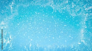 Frozen window with patterns on it. Outside the window it is snowing on a blue background. Beautiful background for the holidays Christmas or New Year.