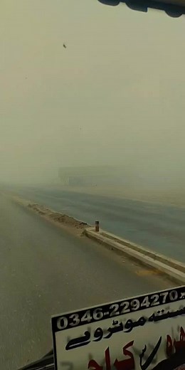 Foggy Highway Driving: Vehicles on a Misty Road