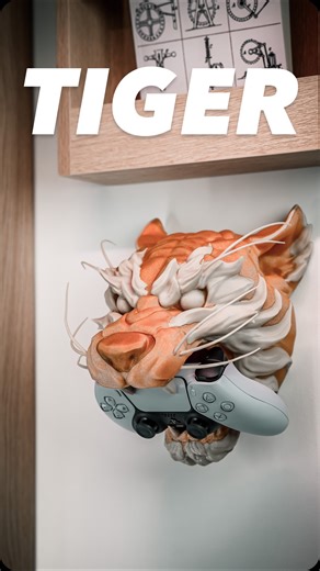 Holoprops - Pierre-Henri Paitre on Instagram: "The Tiger Controller Stand has entered the arena! 🐯🎮 Fourth beast in the Creature Series — after the Dragon 🐉, Snake 🐍, and Wolf 🐺 — this fierce tiger holds your controller with raw power and style. Wall-mount it or let it guard your desk. Compatible with PS5, PS4, Xbox Series X/S, and Switch Pro. Support-free 3D print — gravity + tiger jaws = secure grip with one hand. Printer: @bambulab_official X1C Filament: @bambulab_official Gold Sparkle P