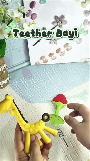 Baby teether in the shape of a strawberry and giraffe. Safe for babies to bite on #teether #teeth...