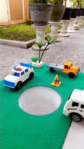 Big car pushing red bus and red truck in pit