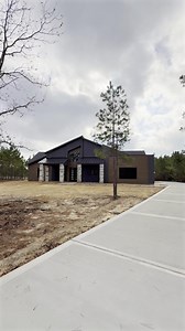 This Modern Mountain Style custom home in Republic Grand Ranch is now complete on a beautiful wooded acreage homesite, where we're proud to be the #1 builder! Inspired by mountain views in Canada, the owners envisioned a unique look that blends English mountainside charm with Texas warmth and smart tech from Design Tech Homes. The bold exterior—dramatic gables, stone columns, wood accents—delivers timeless comfort. The all-electric design and solar farm ensure this home is self-sufficient and fu