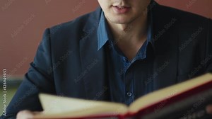 Teacher reads book and lecturing at the schoolroom class close-up