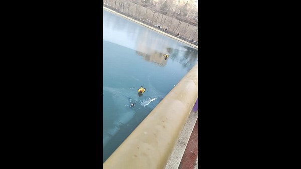 Heroic firefighters crawl across cracking ice to rescue girl who fell through frozen river in China