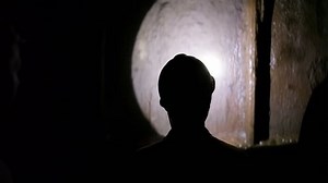 clip-20252635-miner-descends-into-mine-shaft-elevator-cage